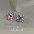 Gold Tone Blue Petal Red Center Flower Earrings In Clip And Stud Styles view 1
