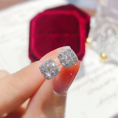 Product view showing silver-tone square clear-stone cluster stud earrings