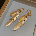 Gold Layered Feather Huggie Earrings with Cutout Details view 6