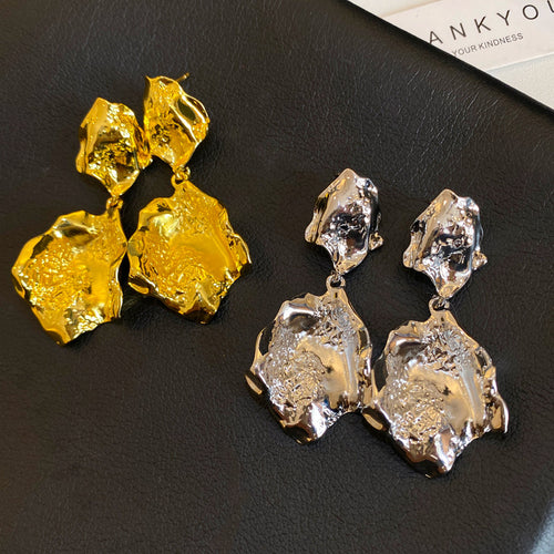 Primary view of irregular hammered metal shapes stacked into bold dangling silhouettes