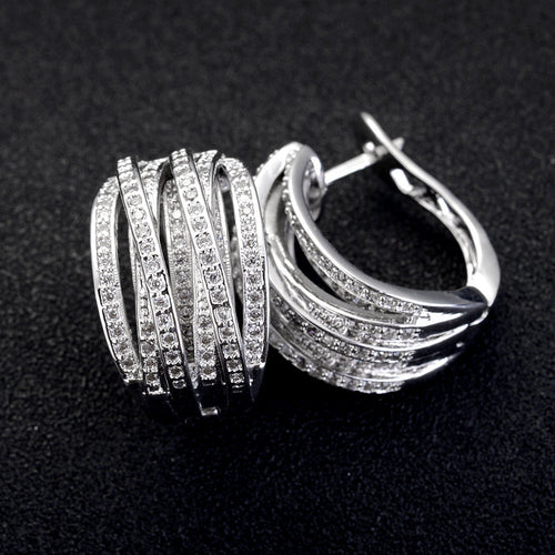 Product view showing silver-tone five-rail pave wide hinged hoop earrings