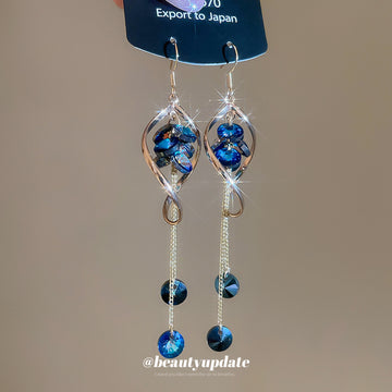Blue Crystal Twisted Loop Dangle Hook Earrings with Polished Metal Details