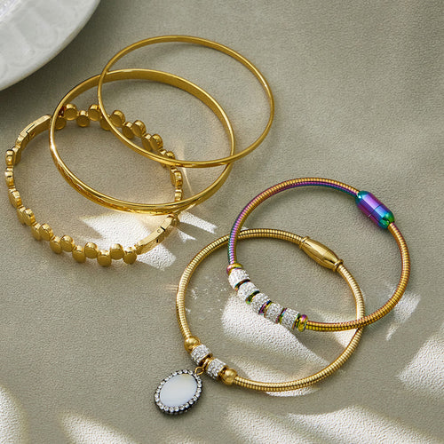 On-wrist view of magnetic and hinged bracelets in main image 1.