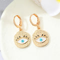Gold Tone Ornate Evil Eye Medallion Huggie Earrings in Eight Designs view 4