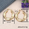 Wide Irregular Hoop Earrings in Gold-Tone Metal Jewelry view 4