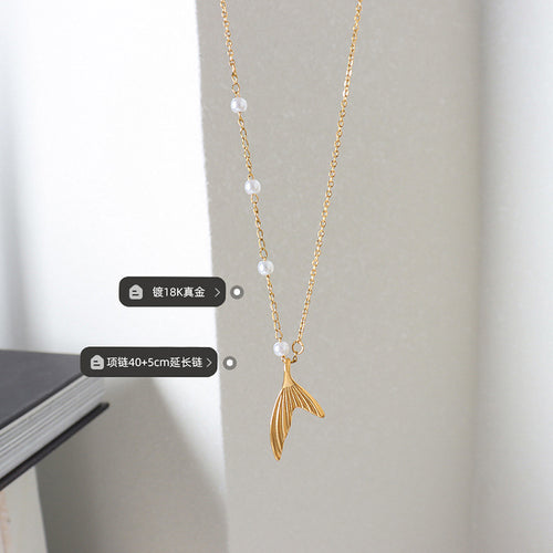 Gold mermaid tail necklace hanging with size and plating labels
