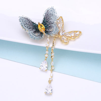 blue fabric butterfly brooch with crystal tassels dangle pin isolated on a white background