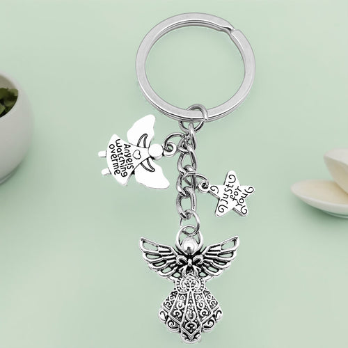 Front product photo of antique silver guardian angel wing and star charm keychain showing the pictured design arrangemen