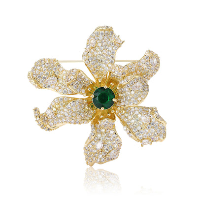 Gold crystal flower brooch green center front on white