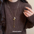 Gold Tone Flower And Ribbon Tassel Pendant Necklace view 3