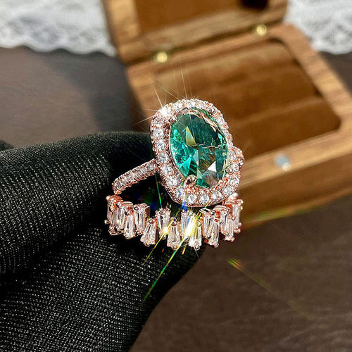 Rose Gold Tone Green Oval Halo Ring and Baguette Band Set shown in alternate angle