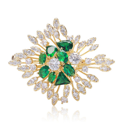 Gold green crystal starburst leaf brooch front on white