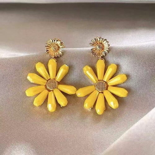 Yellow Daisy Drop Earrings with Textured Brown Centers in modeled view