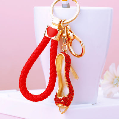 A front product view shows the high heel keychain with its visible ornament and hanging hardware.