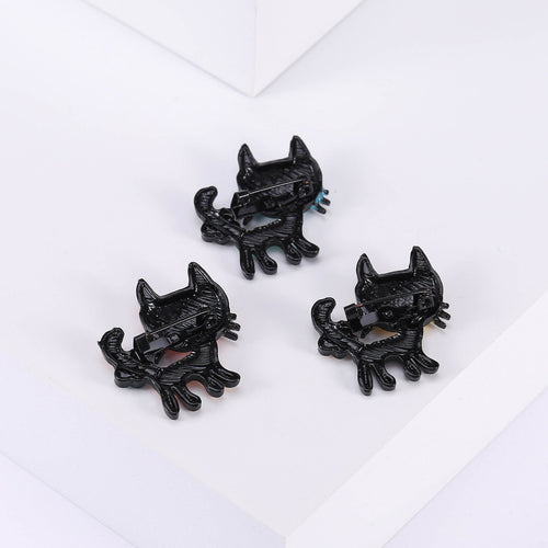 Angled display of three cartoon cats in blue, coral, and yellow, each with playful accessories