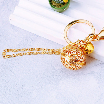 Main image 1 shows a supplied presentation of filigree palace bell keychain and standalone gold tone with visible attach