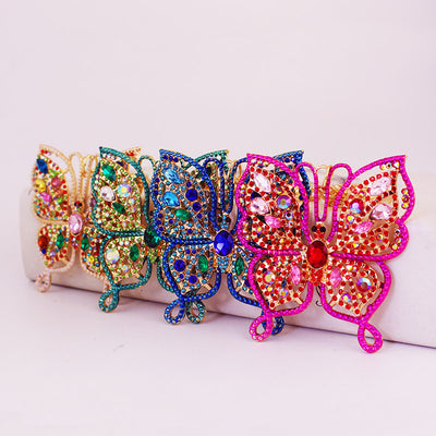 Four butterfly keychains in pink, blue, green, and multicolor finishes stand in a row.