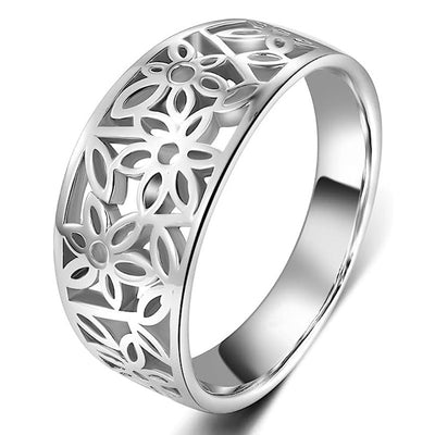 Silver cutout flower wide band ring angled on white background