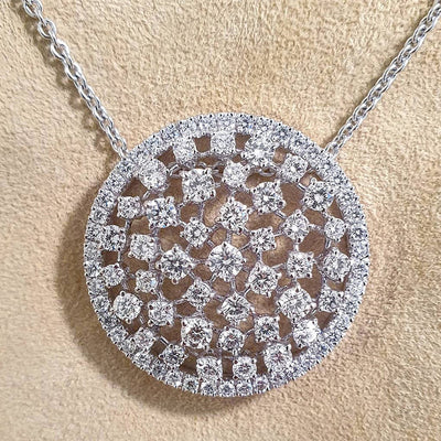 Silver round openwork pave CZ disc pendant on beige fabric