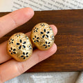 Gold Tone Oval Stud Earrings With Black Floral Cutouts view 2