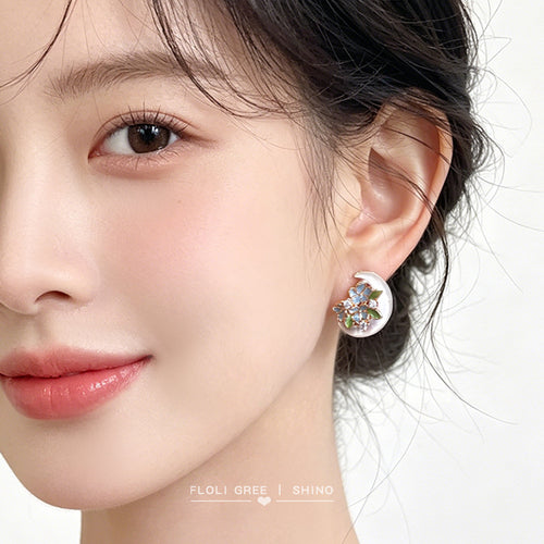 Crescent mother-of-pearl flower stud worn on ear side profile