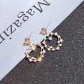 Gold Tone Open Floral Hoop Earrings in Polished Metal view 3