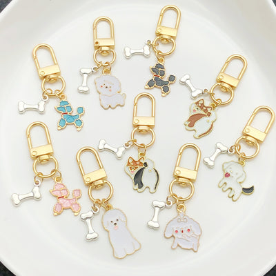 Front display of sixteen dog and bone enamel clasp keychains with visible colors and attached hardware