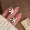 Sculptural Lily Flower Metal Stud Earrings With Decorative Metal Accents view 1
