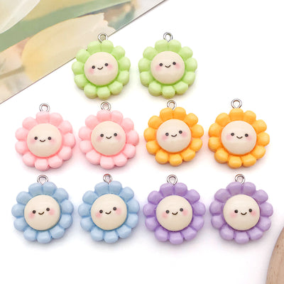 Multicolor sunflower charms arranged on a light background