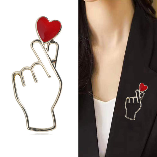 Silver finger heart brooch product shot and worn on black blazer