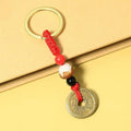 Metal Coin Keychain With Red Cord and Red, White and Black Beads view 3