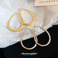 Slim Oval Statement Hoop Earrings in Gold and Silver Tones view 2