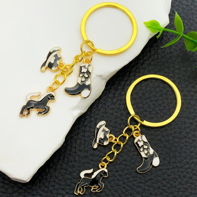 Overview showing the available color and design variations of the black brown white and pink western horse metal keychai