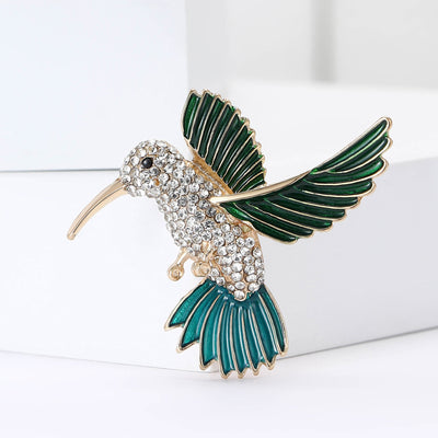 Front view of hummingbird with green enamel wings and a clear crystal body