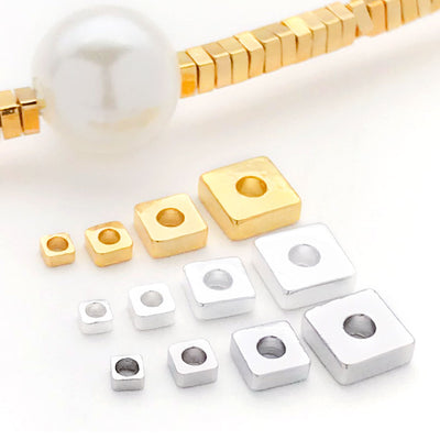Front overview of flat square disc metal spacer beads arranged by finish and size