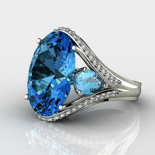 Front view showing a large blue pear-shaped center with clear stone shoulders