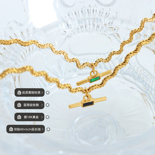 Two gold rope bar pendants green and black glass with material labels