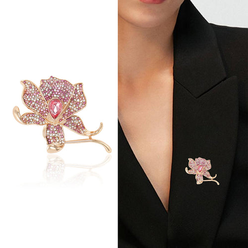 Angled display of the pink crystal rose brooch on a white surface