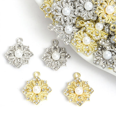 Assorted pearl rhinestone flower charms arranged beside a tray