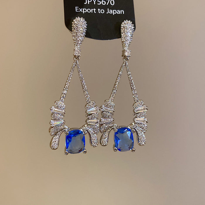 Silver Tone Geometric Drop Earrings With Blue Crystals