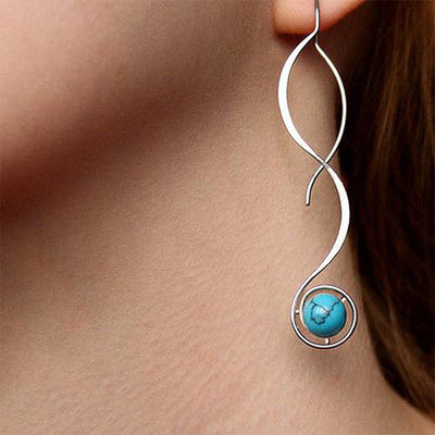 Silver wave turquoise bead drop earring worn on ear