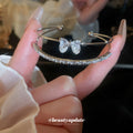 Double Band Bow Open Bangle In Iridescent Gold Gold Or Silver Tone view 2