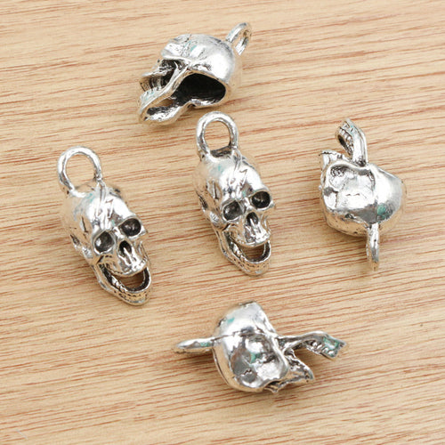 Dimensional skull charms arranged to show surface details
