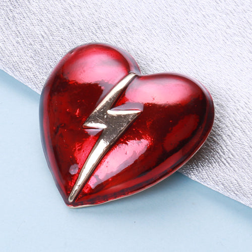 Angled close-up showing crystals on the lightning heart brooch