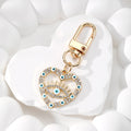 Gold Tone Rhinestone Heart Lash Eye Clip Keychains in Five Colors view 6