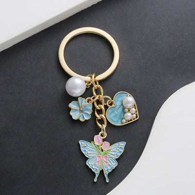 Front product photo of heart pearl rose and butterfly enamel keychain showing the pictured design arrangement