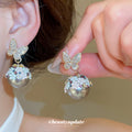 Gold Tone Butterfly Floral Ball Drop Earrings With Polished Metal Details view 2