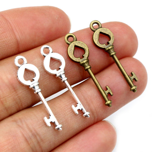 vintage key charms arranged together on a white background