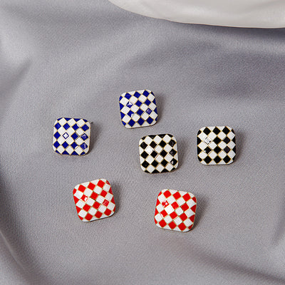 Blue black and red checkerboard square studs scattered on gray satin
