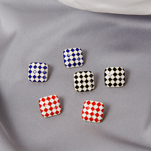 Blue black and red checkerboard square studs scattered on gray satin